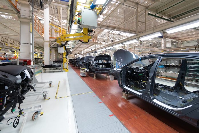 Add details to car body. Robotic equipment makes Assembly of car. Modern car Assembly at factory